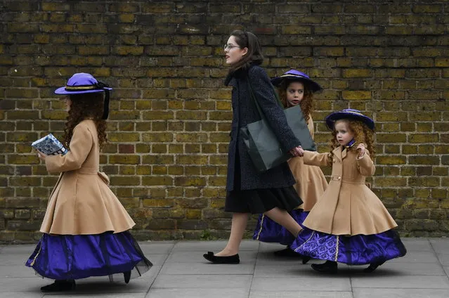Members of the Jewish Community celebrate the festival of Purim in Stamford Hill north London, Britain, 21 March 2019. Purim is a Jewish holiday that commemorates the saving of the Jewish people from Haman according to the Biblical Book of Esther. Families often dress in colourful costume and share gifts. Stamford Hill in north London has the largest concentration of ultra-orthodox Charedi Hasidic Jews in Europe. (Photo by Neil Hall/EPA/EFE)