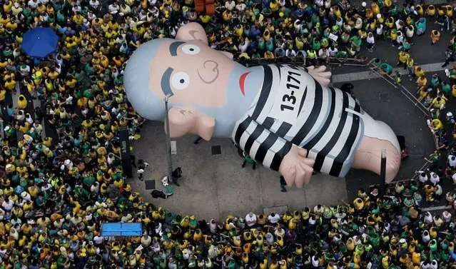 An inflatable doll known as “Pixuleco” of Brazil's former President Luiz Inacio Lula da Silva is seen during a protest against Rousseff, part of nationwide protests calling for her impeachment, in Sao Paulo, Brazil, March 13, 2016. (Photo by Paulo Whitaker/Reuters)