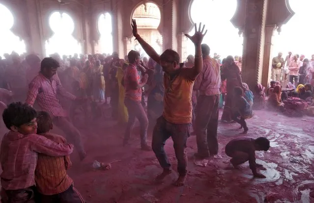 Hindu devotees take part in the religious festival of Holi, also known as the festival of colours, in the town of Barsana in the Uttar Pradesh region of India, March 16, 2016. (Photo by Cathal McNaughton/Reuters)