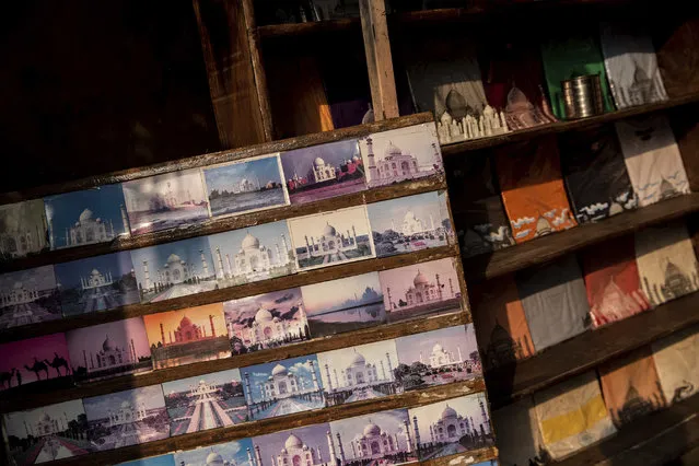 In this Wednesday, January 23, 2019 photo, Taj Mahal postcards are displayed in a souvenir shop in Agra, India. Despite being a UNESCO world heritage site, the mausoleum built by Muslim Mughal emperor Shah Jahan was not included as a listed attraction by the Uttar Pradesh tourism ministry in 2017. Chief minister Adityanath said foreign dignitaries should be gifted with the Bhagavad Gita, a Hindu religious text, instead of a replica of the monument. (Photo by Bernat Armangue/AP Photo)