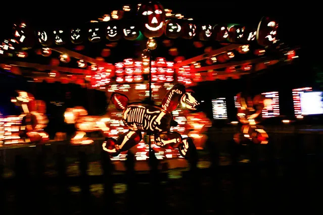 A Carrousel made of pumpkins is illuminated during “The Great Jack OLantern Blaze” at Van Cortlandt Manor on October 27, 2021 in Croton-on-Hudson, New York, ahead of Halloween. (Photo by Kena Betancur/AFP Photo)