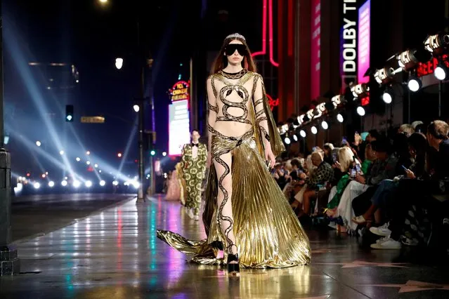 A model walks on the sidewalk of Hollywood Blvd during the Gucci Love Parade fashion show in Los Angeles, California, U.S., November 2, 2021. (Photo by Mario Anzuoni/Reuters)