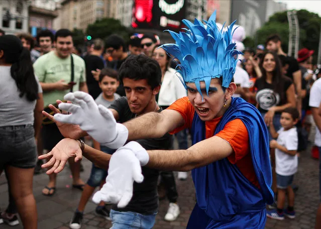 Argentine Dragon Ball fans perform a Kamehameha as they bid a final farewell to Japanese manga comic creator Akira Toriyama, at the Obelisk in Buenos Aires, Argentina on March 10, 2024. (Photo by Agustin Marcarian/Reuters)