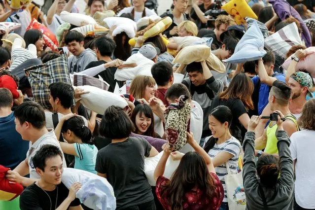 People enjoy a pillow fight at the Chiang Kai-shek Memorial Hall during the International Pillow Fight Day in Taipei, Taiwan, 02 April 2016. (Photo by Ritchie B. Tongo/EPA)