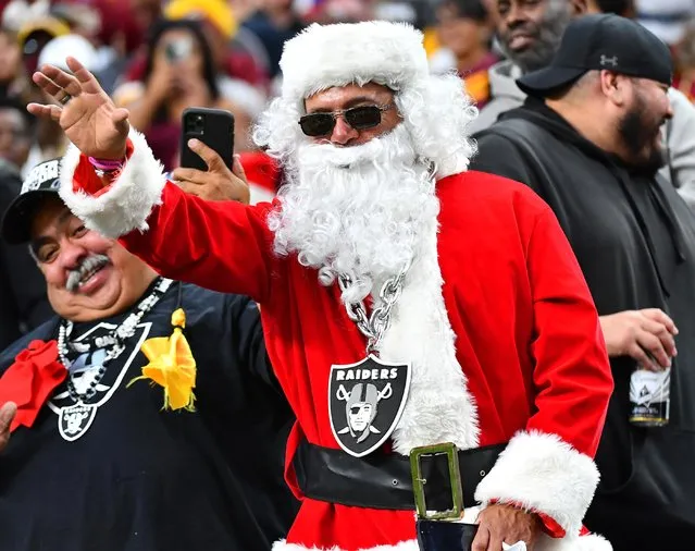 A Las Vegas Raiders fan dressed as Santa waves from the stands during the Raiders' game against the Washington Football Team at Allegiant Stadium in Paradise, Nevada, December 5, 2021. (Photo by Stephen R. Sylvanie/USA TODAY Sports)