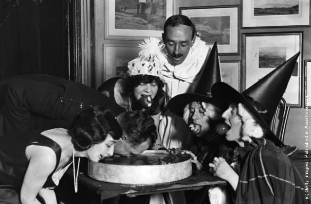 1922: An apple bobbing game at a Halloween fancy-dress party