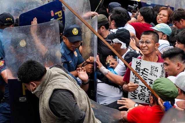 Police officers block Filipino activists from marching towards the U.S. Embassy during a Labor Day protest in Manila, Philippines on May 1, 2024. (Photo by Lisa Marie David/Reuters)