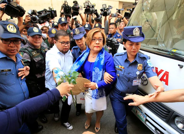 Philippine police escort Leila de Lima, a senator detained on drug charges, on her way to a local court to face an obstruction of justice complaint in Quezon city, metro Manila, Philippines March 13, 2017. (Photo by Romeo Ranoco/Reuters)
