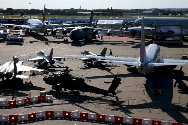 Airplanes are seen on display in the evening at the 51st Paris Air Show at Le Bourget airport near Paris, June 16, 2015. Picture taken June 16, 2015. REUTERS/Pascal Rossignol 