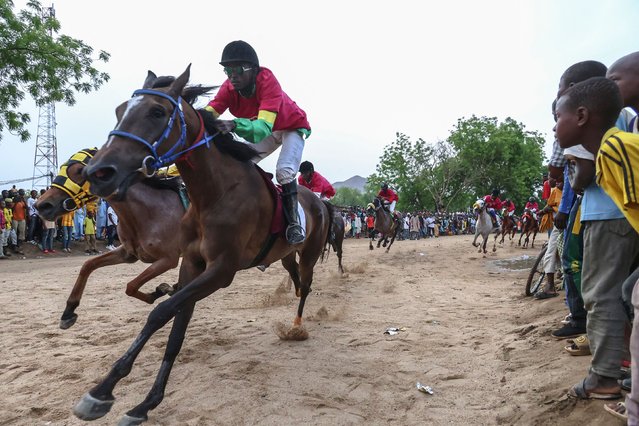 Jockeys (from Cameroon, Chad, Niger and Nigeria) on their horses react during the 12th edition of the Cameroon International Horse Race Grand Prix in Maroua, on May 11, 2024. (Photo by Daniel Beloumou Olomo/AFP Photo)