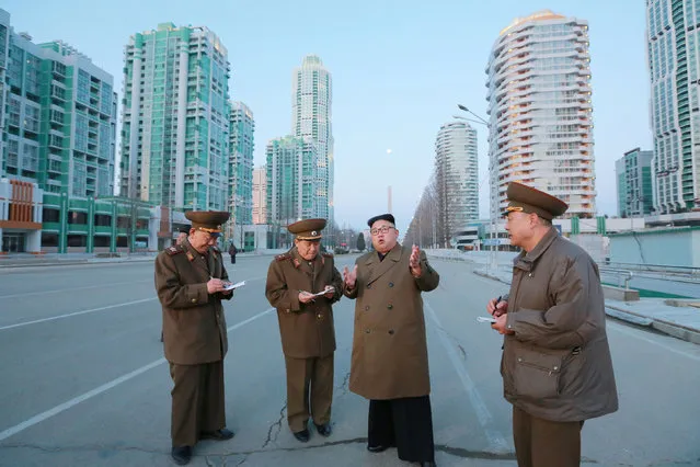 North Korean leader Kim Jong Un provides field guidance at the construction site of Ryomyong Street in this undated picture provided by KCNA in Pyongyang on March 16, 2017. (Photo by Reuters/KCNA)