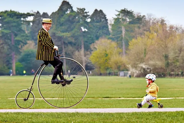 Stuart Mason-Elliott, president of the Pickwick Bicycle Club and on his original 1872 penny farthing, crosses paths with Arthur Naish, two, in Southampton, United Kingdom on April 1, 2021. (Photo by Jordan Pettitt/Solent News)