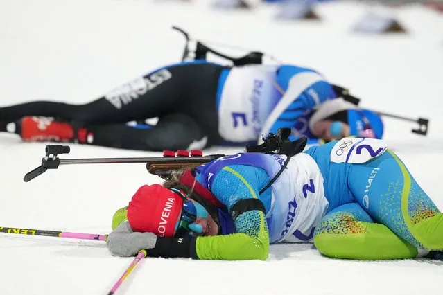 Slovenia's Polona Klemencic (front) and Estonia's Tuuli Tomingas react after crossing the finish line in the Biathlon Women's 15km Individual event, on February 07, 2022 at the Zhangjiakou National Biathlon Centre, during the Beijing 2022 Winter Olympic Games. (Photo by Athit Perawongmetha/Reuters)