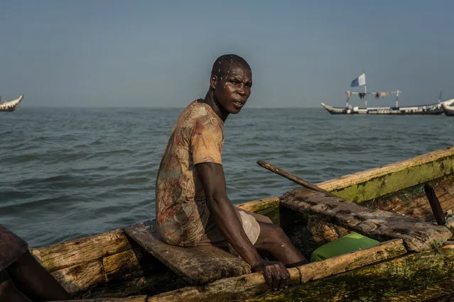 Eric Quaye Ade, a Ghanaian fisherman in the waters of the Gulf of Guinea where he has been working for almost twenty years, outside Jamestown, the oldest fishing community in Accra on July 21, 2019. Due to illegal fishing trawlers, unsustainable fishing practices like the use of dynamite, fish stock is depleting in the Gulf of Guinea, raising huge concerns for the local fishing communities whose livelihood depends on their work at sea. (Photo by Natalija Gormalova/AFP Photo)