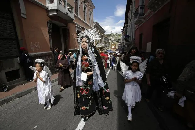 In this June 14, 2015 photo, a woman dressed as Our Lady of Sorrows, takes part in a procession marking Ecuador's identity as a Catholic nation with its consecration to the Sacred Heart of Jesus in Quito. (Photo by Dolores Ochoa/AP Photo)