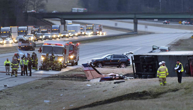 Emergency personnel work at the scene where a twin-engine Beechcraft Barron plane crashed into the tractor-trailer on Interstate 85 South, near the Davidson County Airport in Lexington, N.C., Wednesday, Feb. 16, 2022. (Photo by Walt Unks/The Winston-Salem Journal via AP Photo)