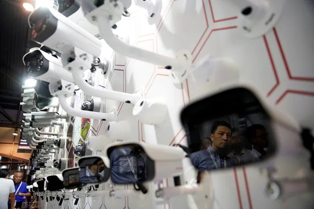 A man is reflected on surveillance cameras at the annual Huawei Connect event in Shanghai, China on September 18, 2019. (Photo by Aly Song/Reuters)