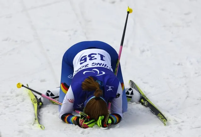 Johanna Recktenwald (Paralympic classification, B2) of Germany lies exhausted on the ground after the sprint race in Zhangjiakou, China on March 9, 2022. (Photo by Gonzalo Fuentes/Reuters)