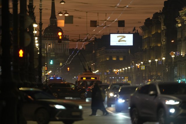 The sign Z, which has become a symbol of the Russian military, and words reading “We don't abandon our own” is displayed over Nevsky Prospect in St. Petersburg, Russia, March 5, 2022. (Photo by AP Photo/Stringer)