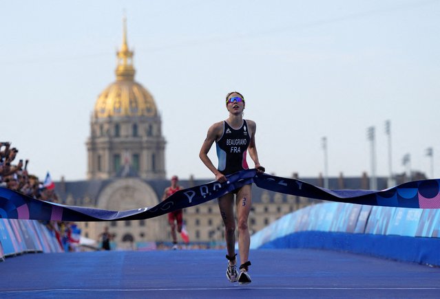 Cassandre Beaugrand of France crosses the line to win the gold medal in the women's individual triathlon at the Paris Olympics on July 31, 2024. (Photo by Aleksandra Szmigiel/Reuters)