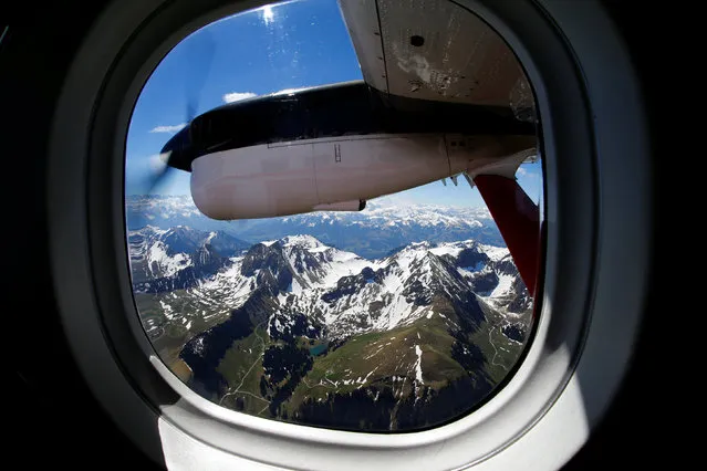 Swiss Alps are pictured through the window of a Swiss Air Force Twin Otter aircraft during a land-surveying presentation flight of the Swiss Federal Office of Topography (swisstopo) above Switzerland to present the the new Leica ADS100 Airborne Digital Sensor camera, producing 3D pictures with a 10 cm resolution, in Belp near Bern, Switzerland, May 17, 2017. (Photo by Denis Balibouse/Reuters)