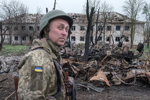 Leonid Serdiuchenko, a Ukrainian commander stands next to destroyed vehicles outside the village of Barvinkove, Kharkiv region, as Russia's invasion on Ukraine continues, in Ukraine, April 12, 2022. (Photo by Marko Djurica/Reuters)