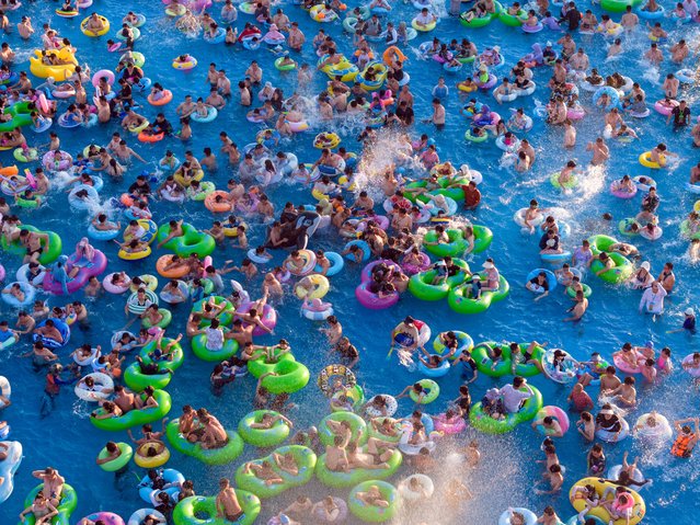 Aerial view of tourists enjoying coolness at a water park on August 4, 2024 in Nanjing, Jiangsu Province of China. Nanjing Meteorological Center on August 4 issued a red alert for high temperatures. (Photo by Xue Jinlong/VCG via Getty Images)