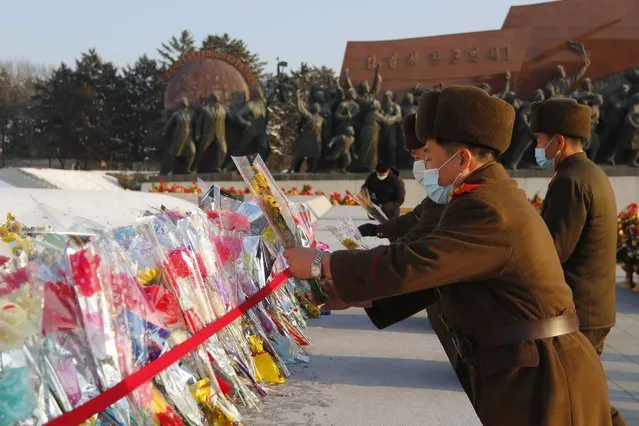 Service personnel of Korean People's Army lay bouquets of flowers at the statues of their late leaders Kim Il Sung and Kim Jong Il on Mansu Hill in Pyongyang, North Korea on the occasion of the 80th birth anniversary of Kim Jong Il on Wednesday, February 16, 2022. (Photo by Jon Chol Jin/AP Photo)