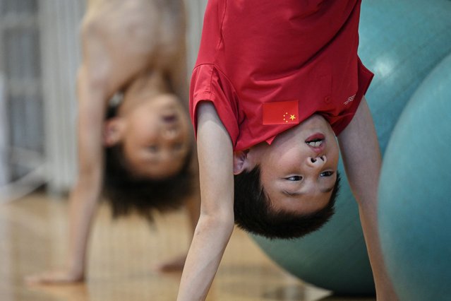 This photo taken on August 12, 2024 shows young divers taking part in strength training at Muxiyuan sport school in Beijing. The splash of young athletes hitting the water and the cries of encouragement from coaches echo through a Beijing swimming pool, where the next generation of Chinese diving champions is being trained. China completed a clean sweep of all eight diving gold medals in the Paris 2024 Olympic Games – a historic first – and their success is inspiring others back home. (Photo by Jade Gao/AFP Photo)