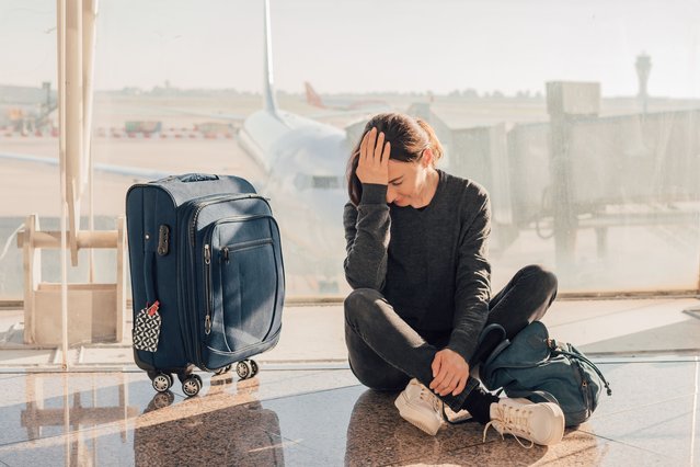 Sad (tired) woman sitting in the airport – missed or cancelled flight concept. (Photo by Alina Rosanova/Getty Images)