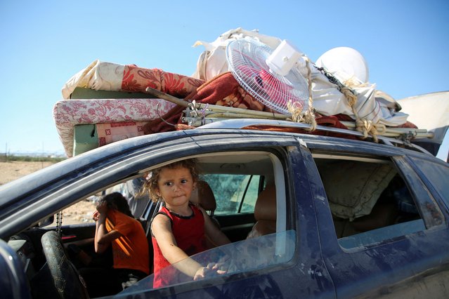 A child looks out of a vehicle, as displaced Palestinians flee Hamad City following an Israeli evacuation order, amid the Israel-Hamas conflict, in Khan Younis in the southern Gaza Strip, on August 16, 2024. (Photo by Hatem Khaled/Reuters)