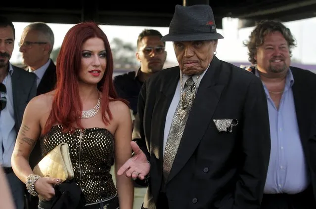 Joe Jackson (2nd R), patriarch of the Jackson family of musical performers and french singer Angelina Silitti visit the Brazilian soccer club Corinthians training center in Sao Paulo, Brazil, July 24, 2015. Jackson, patriarch of the Jackson family of musical performers, suffered a stroke in Brazil on Sunday and is being treated in a Sao Paulo hospital. (Photo by Antonio Araujo/Reuters)