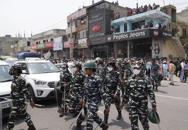Indian paramilitary soldiers leave Shaheen Bagh after officials stopped a demolition drive in New Delhi, Monday, May 9, 2022. (Photo by Manish Swarup/AP Photo)