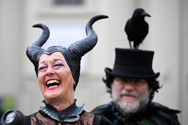 People wearing a Maleficent and crow creative hats enjoy the Bridport Hat Festival at Bucky Doo Square, on September 07, 2024 in Bridport, England. Bridport's quirky Hat Festival features hundreds of participants dressed in elegant, creative, technically ingenious and often bizarre creations. Along with various “Best Hatted” competitions, there is “Hat Hurling” and “Best Hatted Dog” raising money for head-related charities. (Photo by Finnbarr Webster/Getty Images)