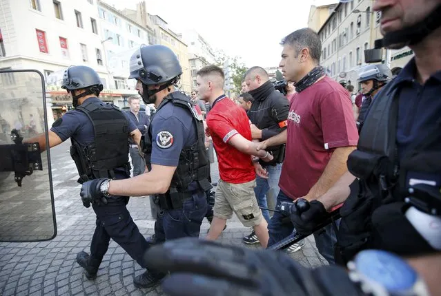 An England fan is detained by riot police ahead of England's EURO 2016 match in Marseille, France, June 10, 2016. (Photo by Jean-Paul Pelissier/Reuters)