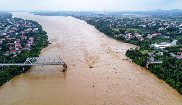 This aerial picture shows the collapsed Phong Châu bridge over the Red River in Phu Tho province on September 9, 2024, after Super Typhoon Yagi hit northern Vietnam. Yagi, the most powerful typhoon to hit northern Vietnam in 30 years according to meteorologists, downed bridges, tore roofs off buildings and damaged factories after making landfall on September 7, 2024. (Photo by AFP Photo/Stringer)