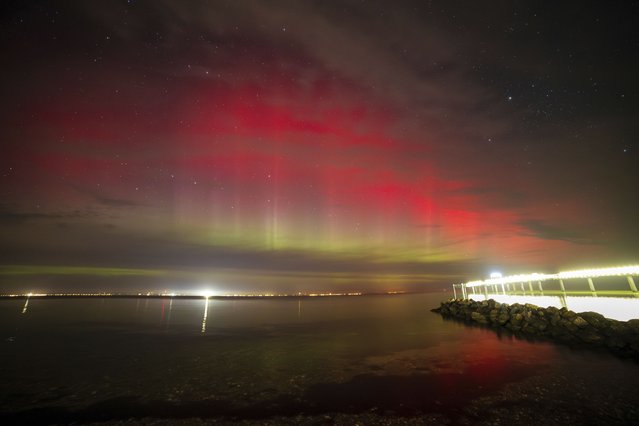 Northern lights shine over the Bay of Lübeck, the Niendorf, Germany, Monday, October 7, 2024. (Phoot by Markus Hibbeler/dpa via AP Photo)