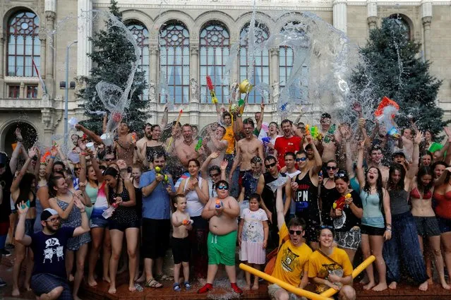 People take part in a water fight in the centre of Budapest, Hungary, June 25,  2016. (Photo by Laszlo Balogh/Reuters)