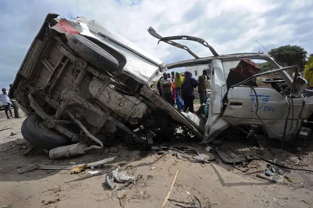This picture taken on June 30, 2016, in Afgooye shows the wreckage of a minibus ripped by a bomb. A roadside bomb ripped apart a minibus just outside Somalia's capital Mogadishu on Thursday, killing at least eight people and injuring several others, a witness said. “There was a terrible incident, a landmine hit a civilian minibus”, said Mohamed Wedow, a witness at the scene near the town of Afgooye. “At least eight people died and more than 20 others were wounded in the blast”. (Photo by Mohamed Abdiwahab/AFP Photo)