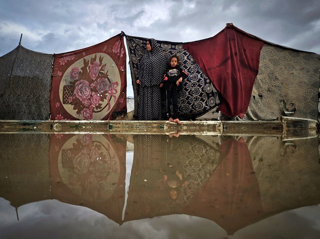 Palestinians living in makeshift tents after fleeing the Israeli army attacks struggle with the rain and cold weather that is effective in Khan Yunis, Gaza on November 26, 2024. The water and mud accumulated in the camp with the rain made the lives of Palestinians living with limited means even more difficult. (Photo by Hani Alshaer/Anadolu via Getty Images)
