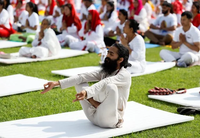 A man performs yoga during an event organised to mark International Yoga Day in Kathmandu, Nepal on June 21, 2022. (Photo by Navesh Chitrakar/Reuters)