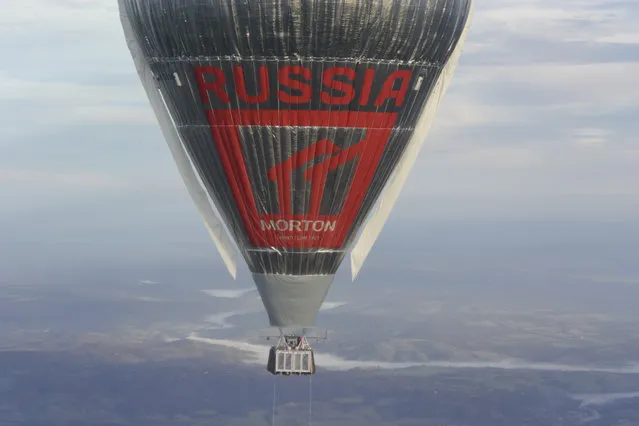 In this Tuesday, July 12, 2016 photo released Wednesday, July 20, 2016 by Morton, Russian adventurer Fedor Konyukhov floats at more than 6,000 meters (20,000 feet) above an area close to Northam in Western Australia state in his helium and hot-air balloon as he makes a record attempt to fly solo in a balloon around the world nonstop. Konyukhov, 65, was battling sleep deprivation, freezing temperatures and ice in his oxygen mask as he nears the end of his record attempt to fly solo around the world nonstop, his son said on Wednesday July 20, 2016. (Photo by Oscar Konyukhov/Morton via AP Photo)