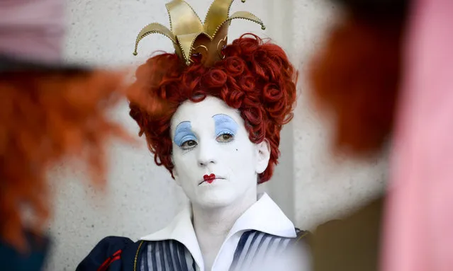 Lorraine Ouellette, a member of the League of Hatters, poses for a photo in between two Mad Hatters on day one of Comic-Con International held at the San Diego Convention Center Thursday, July 21, 2016, in San Diego. (Photo by Denis Poroy/Invision/AP Photo)