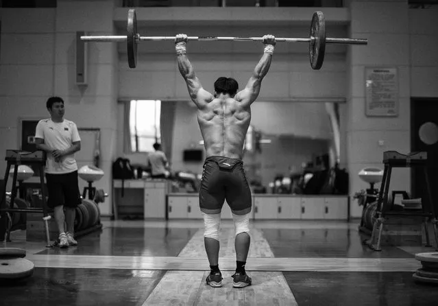 Chinese weightlifter Chen Lijun, who competes in the 62 kg weightclass, lifts during a training session in preparation for the Rio Olympics at the Training Center of General Administration of Sports in China on July 15, 2016 in Beijing, China. Lijun won the World Championships in 2013 and 2015 and is a world record holder. (Photo by Kevin Frayer/Getty Images)