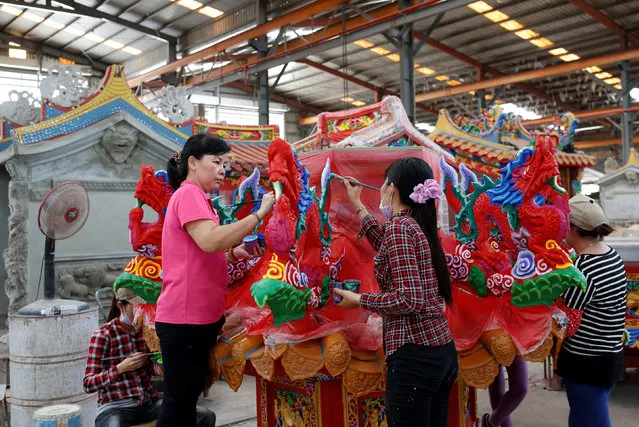 Employees paint a ready-made Chinese traditional temple at the Chuanso factory that manufactures religious objects in Pingtung, Taiwan July 5, 2016. (Photo by Tyrone Siu/Reuters)