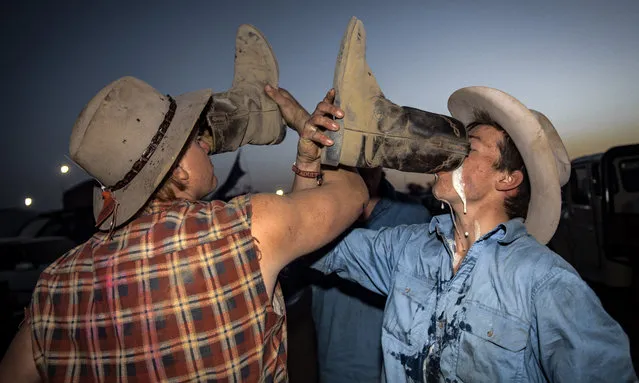 Participants drink out of their boots at the 2017 Deni Ute Muster on September 30, 2017 in Deniliquin, Australia. The annual Deniliquin Ute Muster is the largest ute muster in Australia, attracting more than 18,000 people to the rural town of Deniliquin together to celebrate all things Australian and the icon of the Ute in a weekend of music, competitions and camping. (Photo by Perry Duffin/AAP)