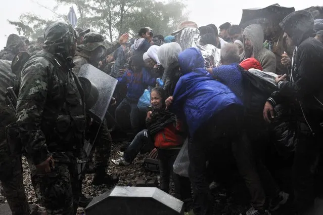 Migrants and refugees clashes with police at the Greek-Macedonian border near the village of Idomeni, in northern Greece on September 10, 2015. (Photo by Sakis Mitrolidis/AFP Photo)