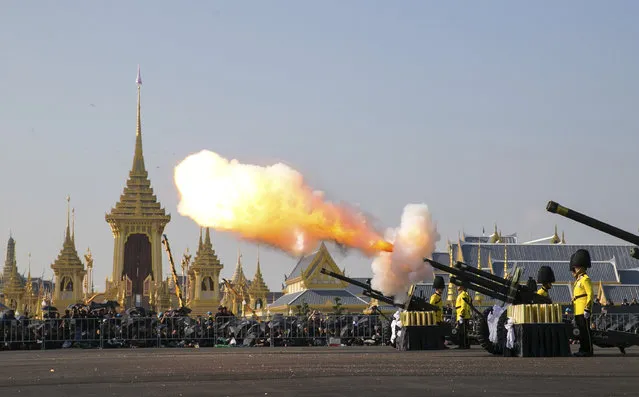 An artillery gun is fired at the funeral procession and royal cremation ceremony of late Thai King Bhumibol Adulyadej, in Bangkok, Thailand, Thursday, October 26, 2017. (Photo by Wason Wanichakorn/AP Photo)