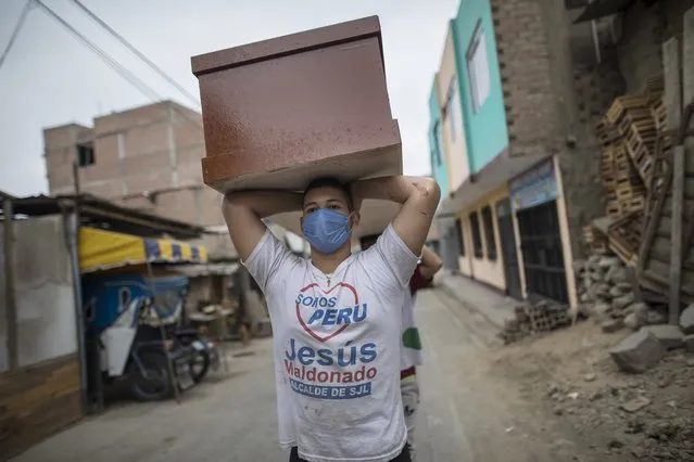 A worker, a migrant from Venezuela, carries a newly made coffin for victims of COVID-19, to a storeroom at a coffin factory in the Juan de Lurigancho neighborhood of Lima, Peru, Thursday, June 4, 2020. As the number of COVID-19 deaths in Peru rapidly mounts, the South American country is becoming one of the epicenters for the virus outbreak in Latin America. (Photo by Rodrigo Abd/AP Photo)