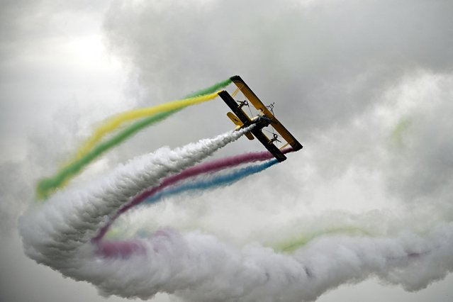 Artists perform on a Grumman G-164A Ag-Cat aircraft during the Antidotum airshow in Leszno, Greater Poland region, on June 21, 2024. (Photo by Sergei Gapon/AFP Photo)